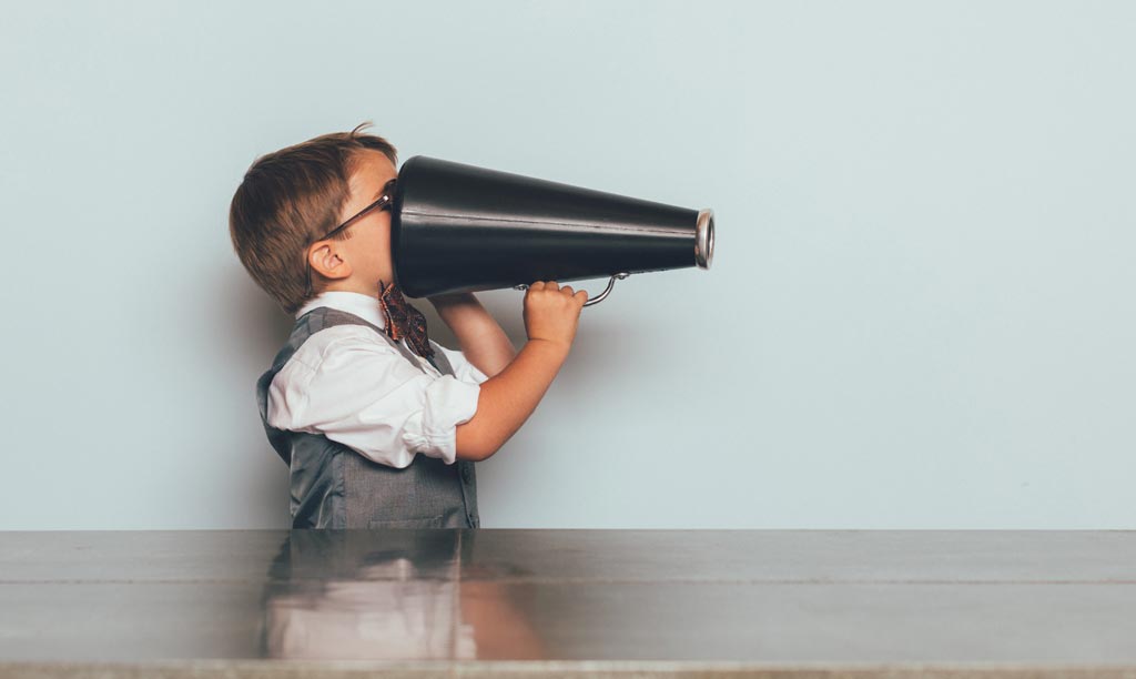 Child using megaphone the wrong way round